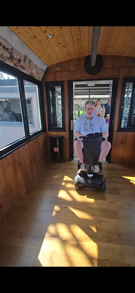 Mobile4Ever customer on a mobility scooter in a Vienna Giant Ferris Wheel cabin at the Prater